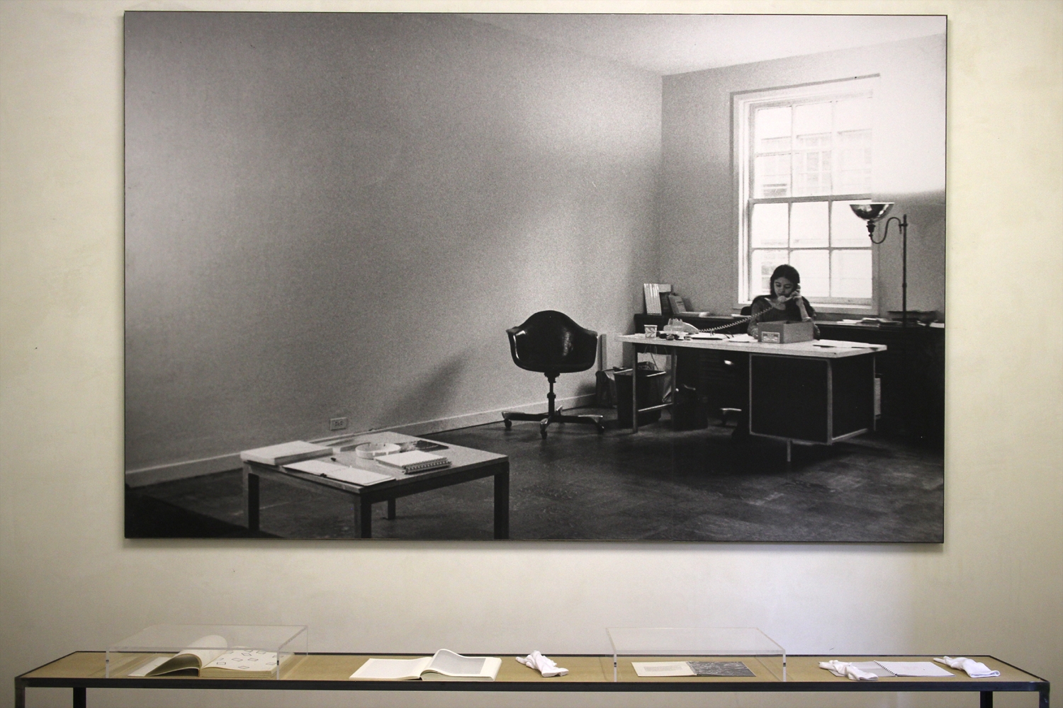 Seth Siegelaub (USA) Installation view of the exhibition, 'January 5-31, 1969' with work by Lawrence Weiner (desk, receptionist, Adrian Piper, with the catalogue), MoMA, New York. B&W photograph Courtesy of the Stichting Egress Foundation, Amsterdam